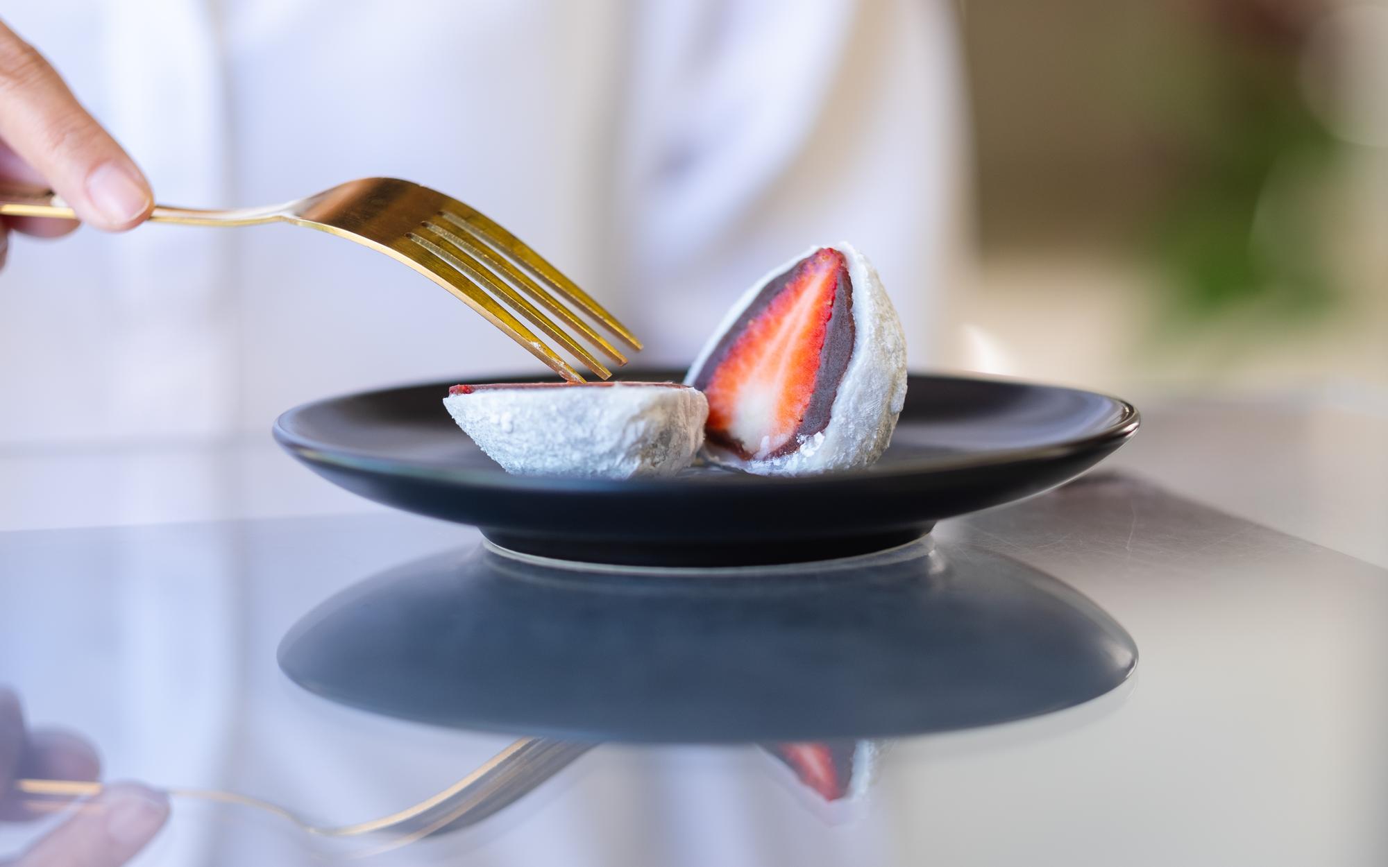 Chef plating a modern dish on slate